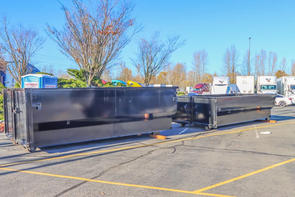 Professional dumpster rental service with roll-off container on residential driveway in Montpelier